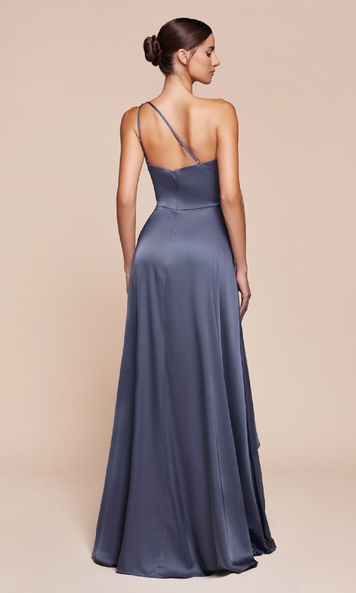 A woman models the Ladivine 7450 One-Shoulder Long A-Line Prom Dress in slate blue satin, featuring a fitted bodice and asymmetric thin straps, shown from the back against a plain neutral background.